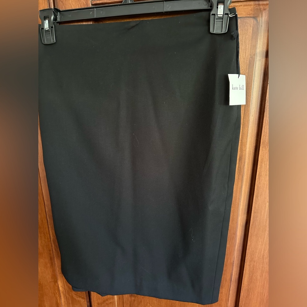 Black lined skirt above knee. Never worn.